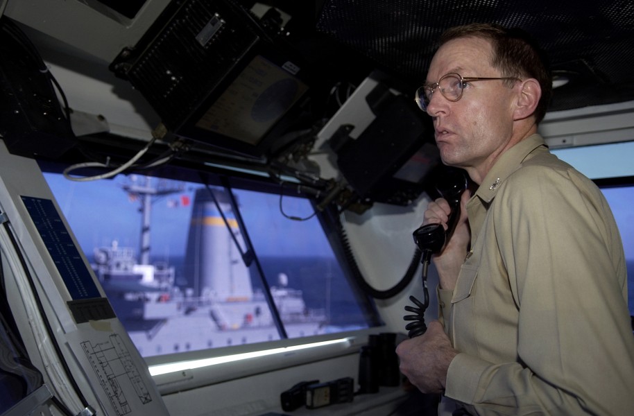 US Navy 051104-N-4776G-158 Commanding Officer, USS Ronald Reagan (CVN 76), Capt. James Symonds, oversees an underway replenishment on the navigation bridge