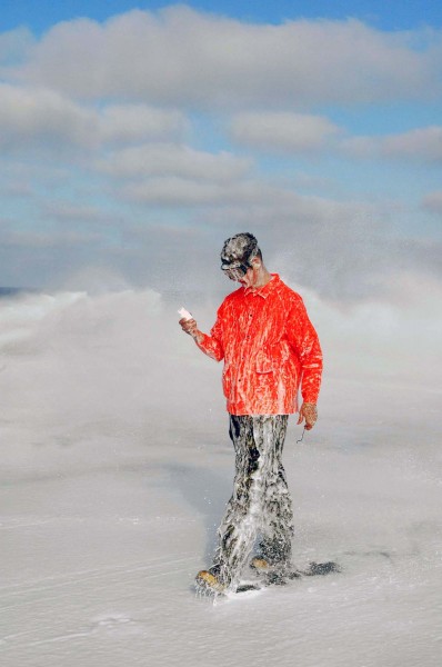 US Navy 060111-N-5384B-025 Airman Michael Lyons assigned to Air Department inspects a sample of Aqueous Film Forming Foam (AFFF), during a test of the sprinkler system