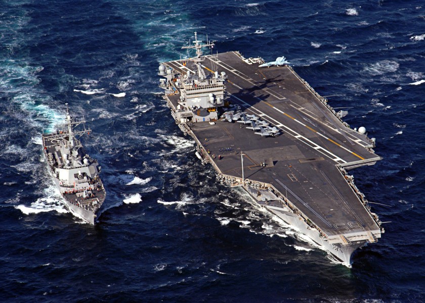 US Navy 060206-N-7748K-002 The nuclear-powered aircraft carrier USS Enterprise (CVN 65) prepares to conduct a refueling at sea with the guided missile destroyer USS McFaul (DDG 74)