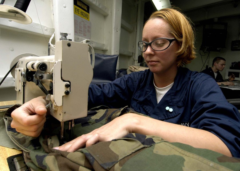 US Navy 060320-N-9079D-008 Aircrew Survival Equipmentman Airman Katherine S. Effle, sews battle dress uniforms (BDU) aboard the Nimitz-class aircraft carrier USS Abraham Lincoln (CVN 72)