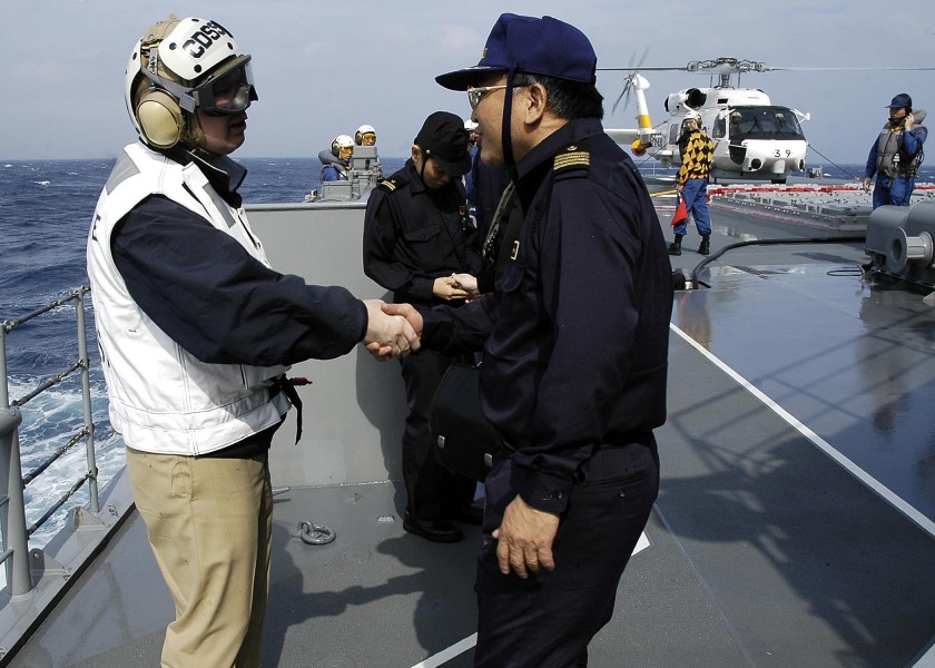 US Navy 060322-N-5837R-022 Commander Destroyer Squadron Nine (CDS-9) Capt. Jeffrey Harley, bids farewell to Cruiser Destroyer Squadron Six One (CDS-61) Capt. Katsuaki Amakawa, aboard JDS Kirishma (DDG 174)