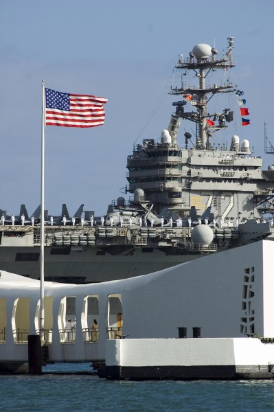 US Navy 060630-N-8157C-062 USS Abraham Lincoln (CVN 72) passes the USS Arizona Memorial as it enters Pearl harbor for a scheduled port visit before the start of Rim of the Pacific (RIMPAC) 2006