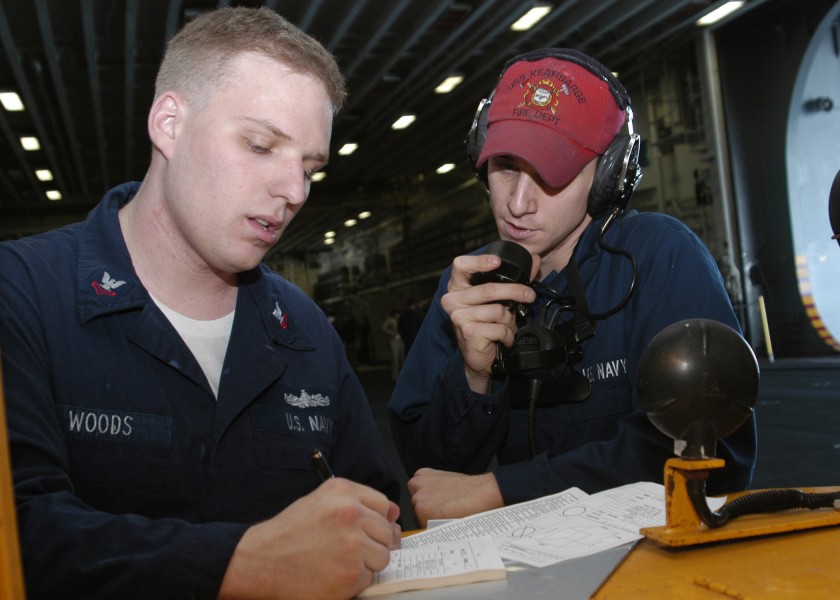 US Navy 061101-N-7292N-036 Damage Controlman Fireman John Bukovinsky relays a message through the ship's sound powered phone system