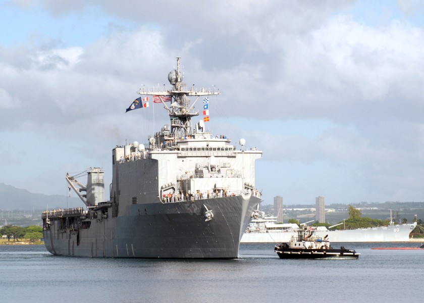 US Navy 061204-N-4965F-004 Sailors aboard dock landing ship USS Pearl Harbor (LSD 52) man the rails as a tugboat assigned to Naval Station Pearl Harbor guides the ship into Pearl Harbor