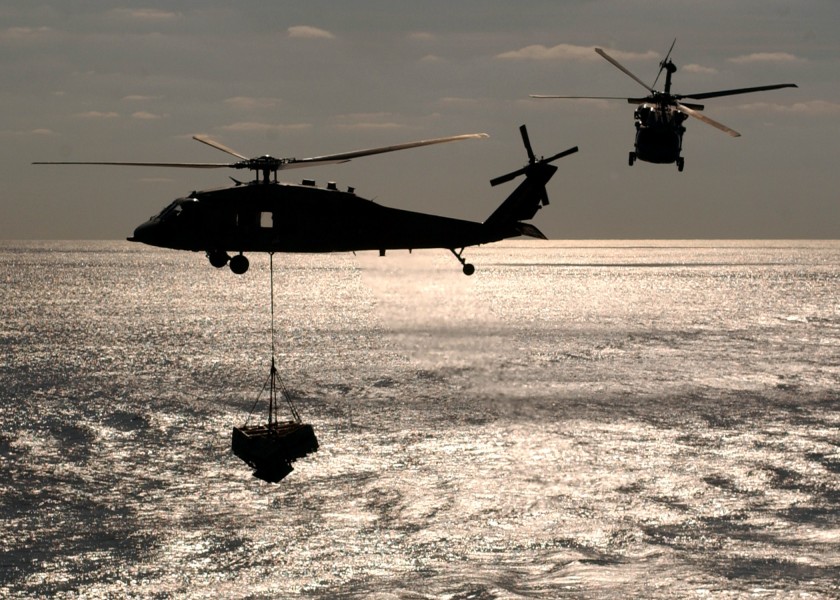 US Navy 061217-N-5416W-001 Two MH-60S Seahawk helicopters assigned to the Chargers of Helicopter Sea Combat Support Squadron Two Six (HSC-26) carries cargo during an underway replenishment