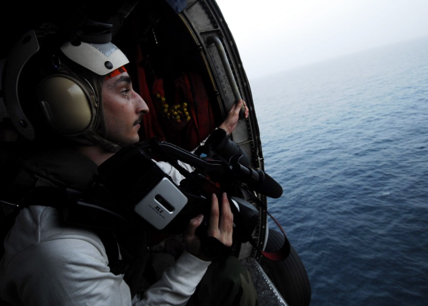US Navy 070310-N-9928E-044 Mass Communication Specialist Seaman Matthew Hepburn takes aerial footage of a replenishment at sea