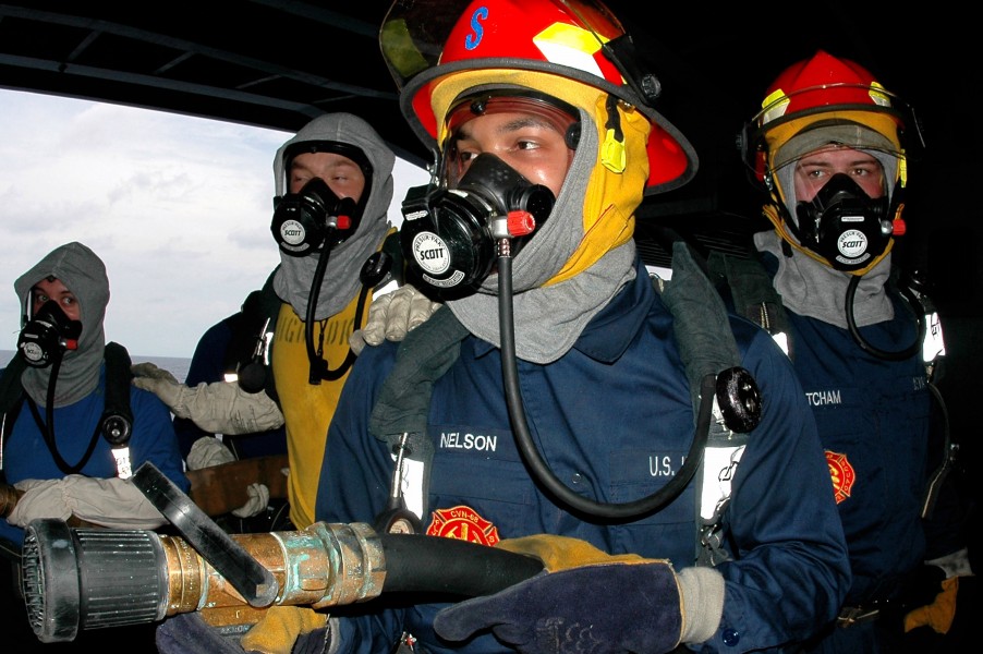 US Navy 070503-N-9760Z-001 Damage Controlman Fireman Aaron Nelson mans a two and one-half inch hose during a Class Bravo fire drill