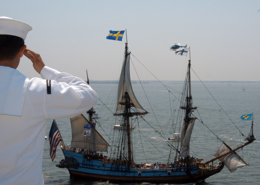US Navy 070608-N-1238B-101 A Sailor salutes a ship from the flight deck of the amphibious assault ship USS Wasp (LHD 1) during the Sail Virginia 2007 celebration