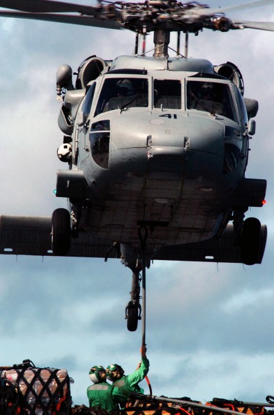 US Navy 070806-N-3038W-282 Sailors aboard the Military Sealift Command fast-combat support ship USNS Bridge (T-AOE 10) attach a cargo pendant to an MH-60S Seahawk