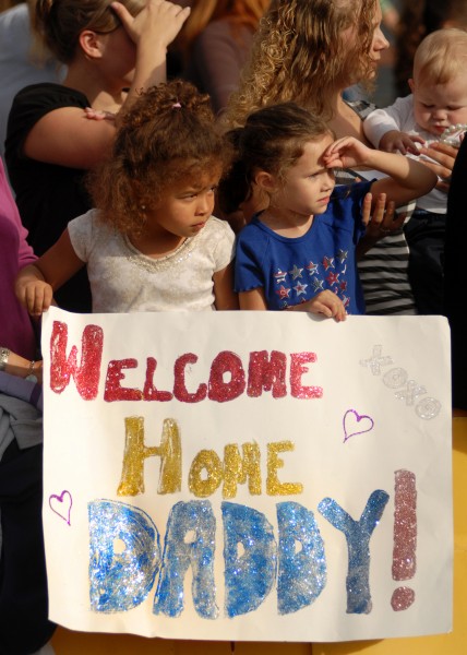 US Navy 070820-N-7981E-156 Family members await the arrival of their loved ones as Sailors disembark Nimitz-class aircraft carrier USS Abraham Lincoln (CVN 72) after her arrival home