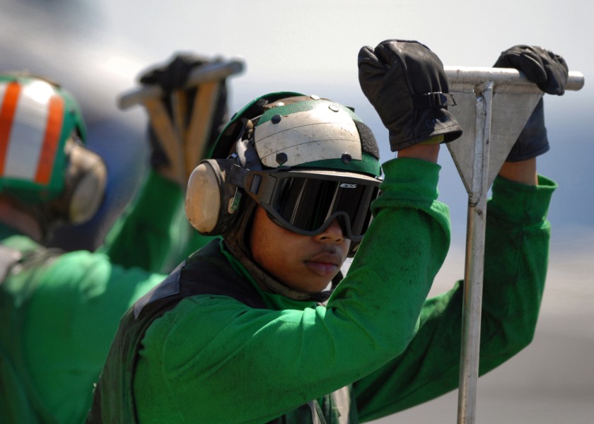 US Navy 070924-N-7981E-667 A Sailor stands ready to guide arresting gear cables back in place during flight operations aboard Nimitz-class aircraft carrier USS Abraham Lincoln (CVN 72)