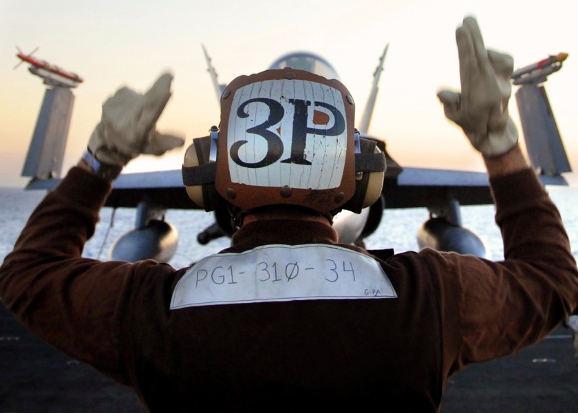 US Navy 071029-N-7981E-216 A plane captain assigned to Strike Fighter Squadron (VFA) 34, directs a pilot performing pre-flight checks on his aircraft