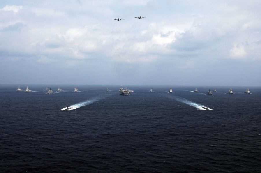 US Navy 071116-N-6106R-157 Two Japan Maritime Self-Defense Force (JMSDF) P-3C Orion patrol aircraft fly over a group of 19 American and Japanese naval ships at the end of ANNUALEX 19G, the maritime component of the U.S.-Japan e
