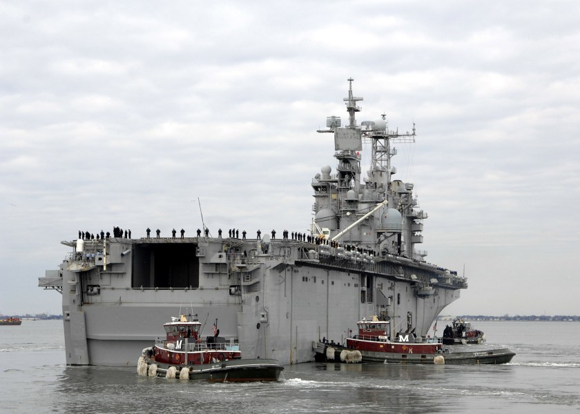 US Navy 080220-N-5292M-006 Tug boats guide the amphibious assault ship USS Nassau (LHA 4) away from the pier as the ship departs for a six-month deployment