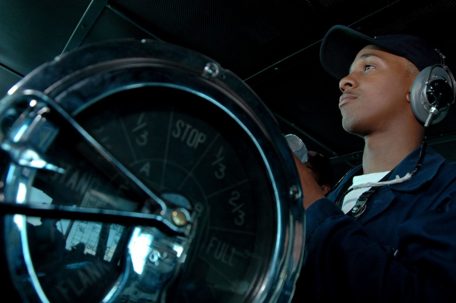 US Navy 080615-N-8854R-026 Seaman Jevon Standback, of Chicago, Ill., stands helmsman watch on the bridge of the aircraft carrier USS Kitty Hawk (CV 63)