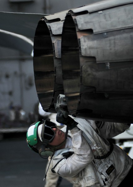 US Navy 080718-N-7981E-588 Aviation Structural Mechanic (Equipment) 2nd Class Donald Perkins checks the tail hook of an F-A-18C Hornet aboard the Nimitz-class aircraft carrier USS Abraham Lincoln (CVN 72)