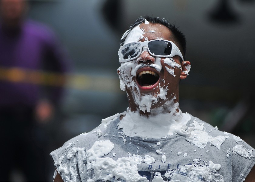 US Navy 080726-N-7981E-418 Hospital Corpsman 1st Class Ferdinand Ajel laughs after taking a pie in the face