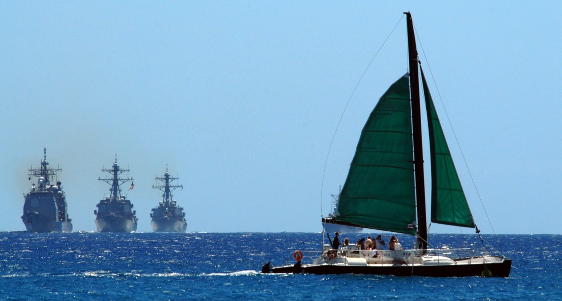 US Navy 080729-N-0879R-001 A sailboat crosses in front of the group of U.S. Navy ship's led by the cruiser USS Lake Erie (CG 70)
