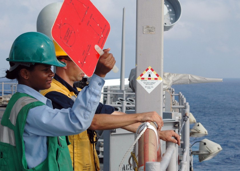 US Navy 080729-N-9134V-102 Seaman Noelle Gilchrist uses a signal paddle during a replenishment at sea