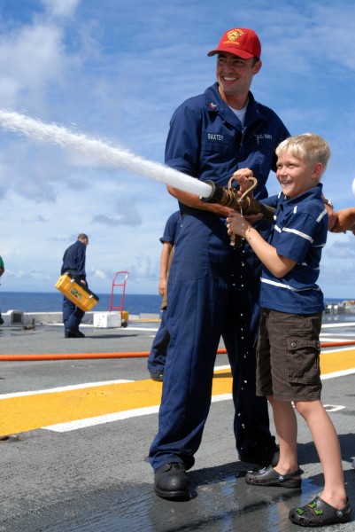 US Navy 080808-N-9905J-119 Damage Controlman 2nd Class Jonathon Baxter directs a firefighting demonstration during Gator Cruise 2008 aboard the amphibious assault ship USS Essex (LHD 2)