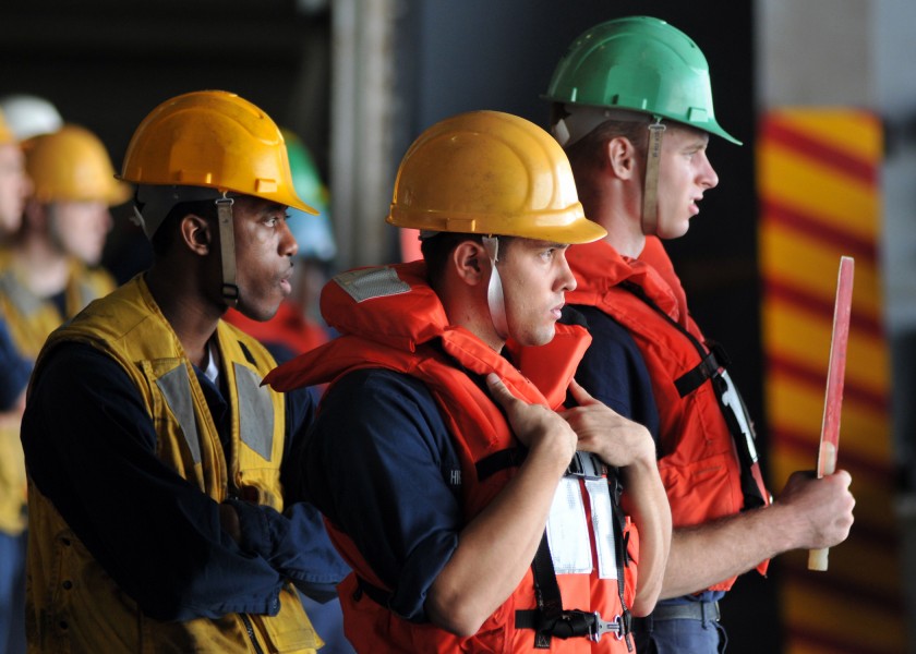 US Navy 080901-N-7981E-161 Rig captains and a signalman wait for the next pallet