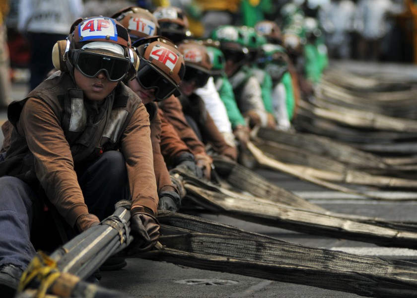 US Navy 080904-N-7981E-109 Flight deck personnel line rig barricades during a drill aboard the Nimitz-class aircraft carrier USS Abraham Lincoln (CVN 72)