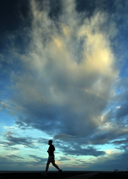 US Navy 080904-N-7981E-401 A Sailor jogs at sunset on the flight deck of the aircraft carrier USS Abraham Lincoln (CVN 72)