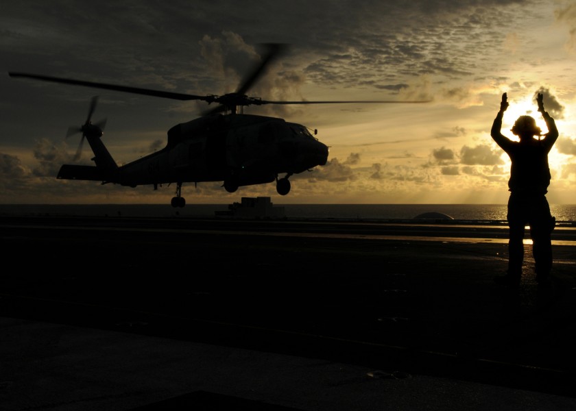 US Navy 080906-N-9898L-262 A landing signalman enlisted directs an HH-60H Sea Hawk assigned to the 