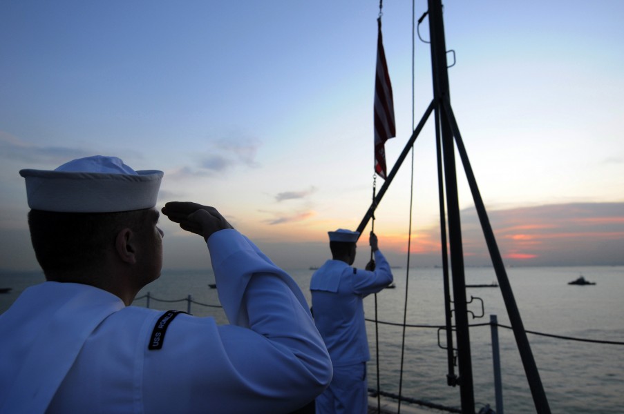 US Navy 081029-N-3659B-024 Sailors lower the Navy Jack
