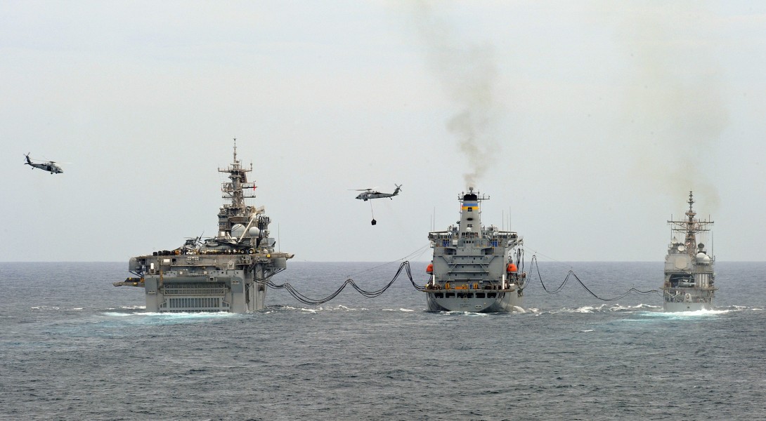 US Navy 090523-N-5345W-062 The amphibious assault ship USS Bataan (LHD 5), left, and the guided missile cruiser USS Anzio (CG 68), right, conduct a replenishment at sea