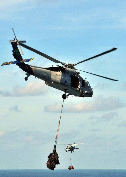US Navy 090725-N-1644H-005 MH-60S Sea Hawk helicopters from the Island Knights of Helicopter Combat Squadron (HSC) 25 conduct a vertical replenishment