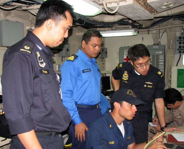 US Navy 090818-N-7058E-047 Republic of Singapore Navy Maj. Ooi Loong, Royal Malaysian Navy Lt. Hisham and Republic of Singapore Navy Capt. K.C. Teo observe U.S. Navy Ensign Duran Cheek