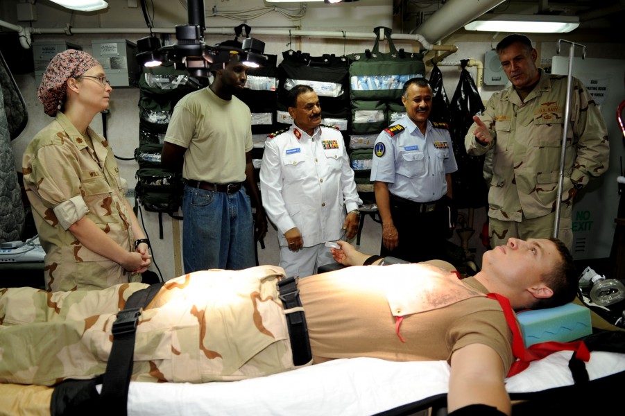US Navy 090912-N-6814F-202 Rear Adm. Scott E. Sanders explains a medical training exercise to Col. Lofta Al Barati and Brig. Gen. Shamshan Radhan during a visit aboard the guided-missile cruiser USS Anzio (CG 68)
