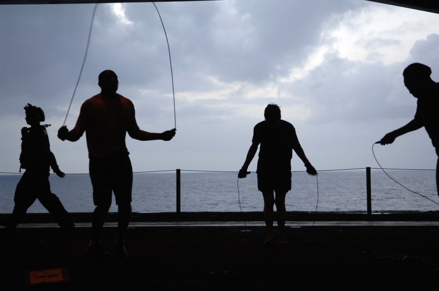US Navy 090913-N-9818V-051 Sailors aboard the aircraft carrier USS Ronald Reagan (CVN 76) conduct morning physical training in the hangar bay of the ship