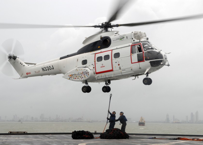 US Navy 091008-N-6692A-078 Seaman Stephen Grande from Cranston, R.I., and Seaman Jeremy Lingle from West Frankfort, Ill., hook up a pendant to a SA-330 Puma helicopter