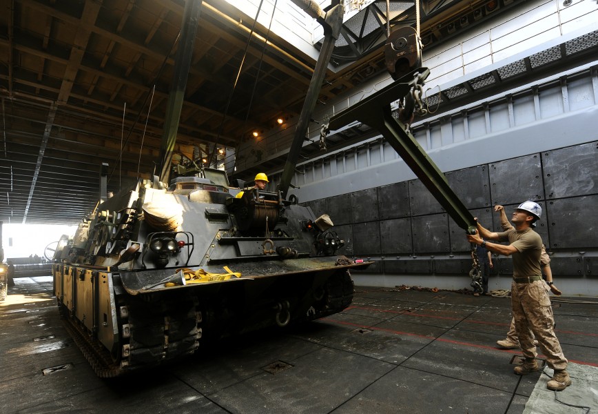 US Navy 091015-N-5345W-100 gt. Alexander Tamez, assigned to Combat Logistics Battalion (CLB) 22 of the 22nd Marine Expeditionary Unit (22 MEU), steadies the lift bar of an M88A2 Hercules recovery vehicle