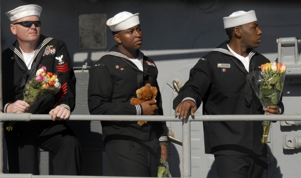 US Navy 091204-N-2456S-079 Fire Controlman 1st Class Jim Buckles, left, Gunner's Mate 2nd Class Al Spivey and Gunner's Mate 3rd Class Charles Talbert wait to reunite with their families