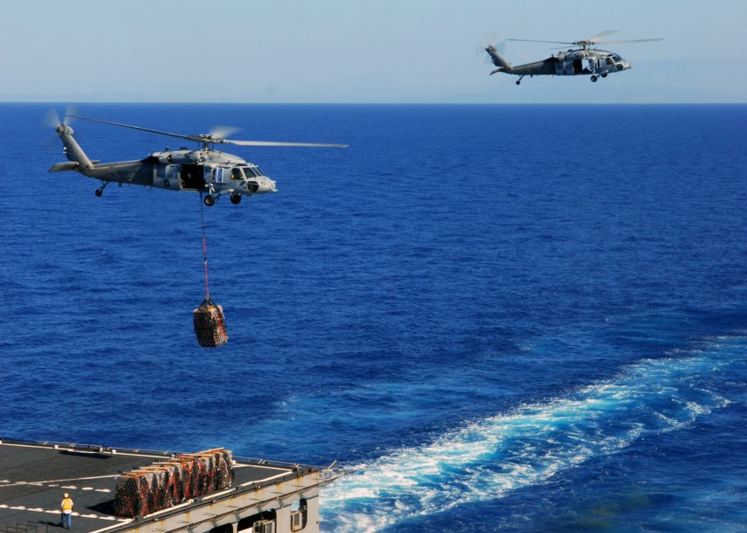 US Navy 100127-N-3165S-041 An MH-60S Sea Hawk helicopter transfers pallets of meals-ready-to-eat from USNS Sacagawea (T-AKE-2) to USS Bataan (LHD 5)
