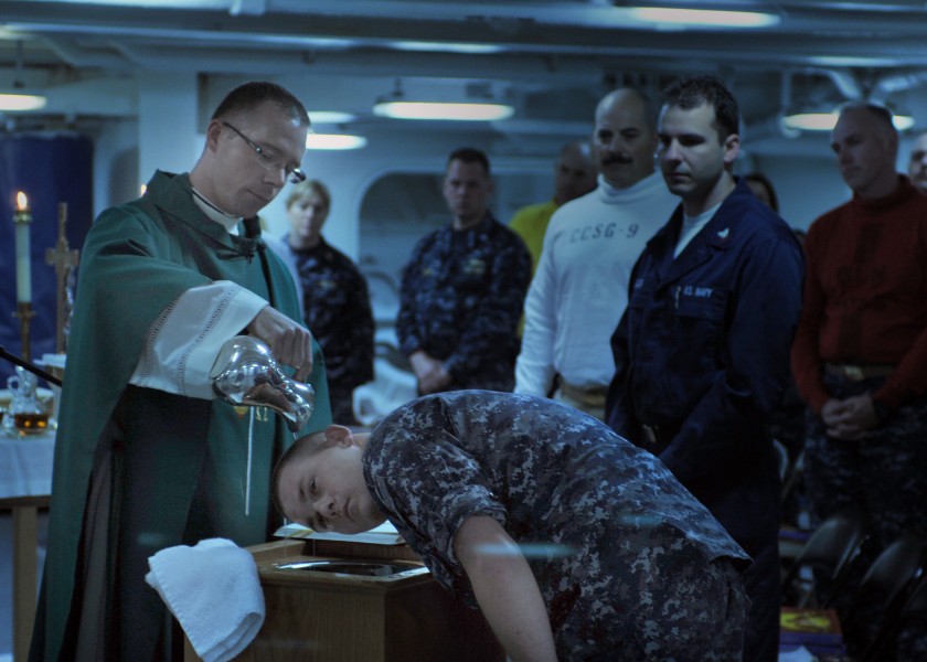 US Navy 100718-N-4973M-050 Chaplain Benton Garrett baptizes Aviation Boatswain's Mate (Fuel) Airman Paul Owen aboard the aircraft carrier USS Abraham Lincoln (CVN 72)