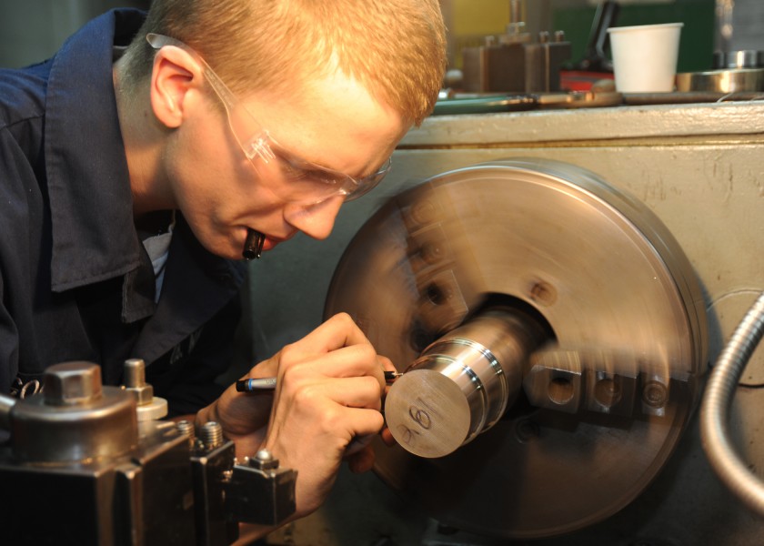 US Navy 100731-N-6092D-151 Machinery Repairman Fireman Nate Goodwin manufactures a valve seat in the machine repair shop aboard USS Abraham Lincoln (CVN 72)