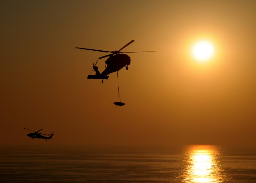 US Navy 100831-N-9196S-401 Two MH-60S Sea Hawk helicopters transit between USS George H.W. Bush (CVN 77) and USS Dwight D. Eisenhower (CVN 69) while conducting a vertical replenishment
