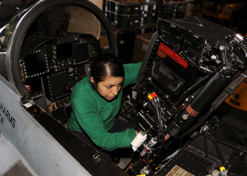 US Navy 101013-N-2218M-001 Aviation Structural Mechanic (Equipment) Airman Deysi Waller performs anti-corrosion maintenance on an F-A-18C Hornet