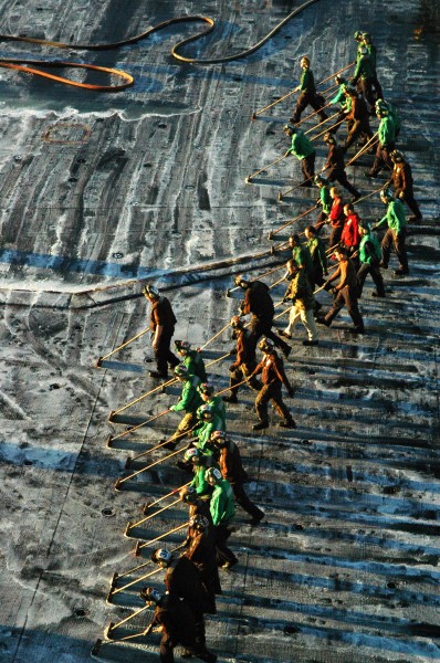 US Navy 101114-N-1240O-148 Sailors aboard the aircraft carrier USS Ronald Reagan (CVN 76) scrub the flight deck during a scrub exercise to clean sa