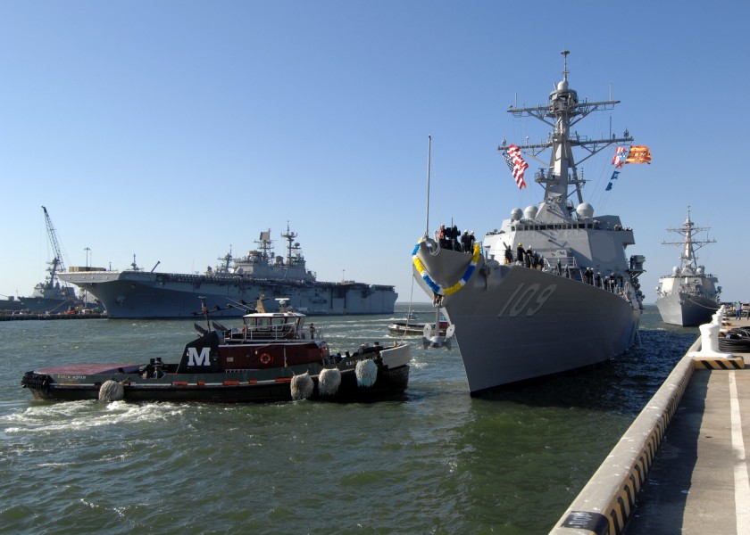 US Navy 101123-N-5292M-250 A tug boat guides the newly commissioned guided-missile destroyer USS Jason Dunham (DDG 109) to its new homeport of Nava