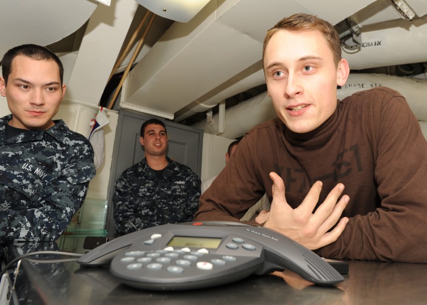 US Navy 101229-N-7095C-020 Aviation Structural Mechanic Airman Apprentice Robert Lamont asks Boston Bruins goalie Tim Thomas a question about the N