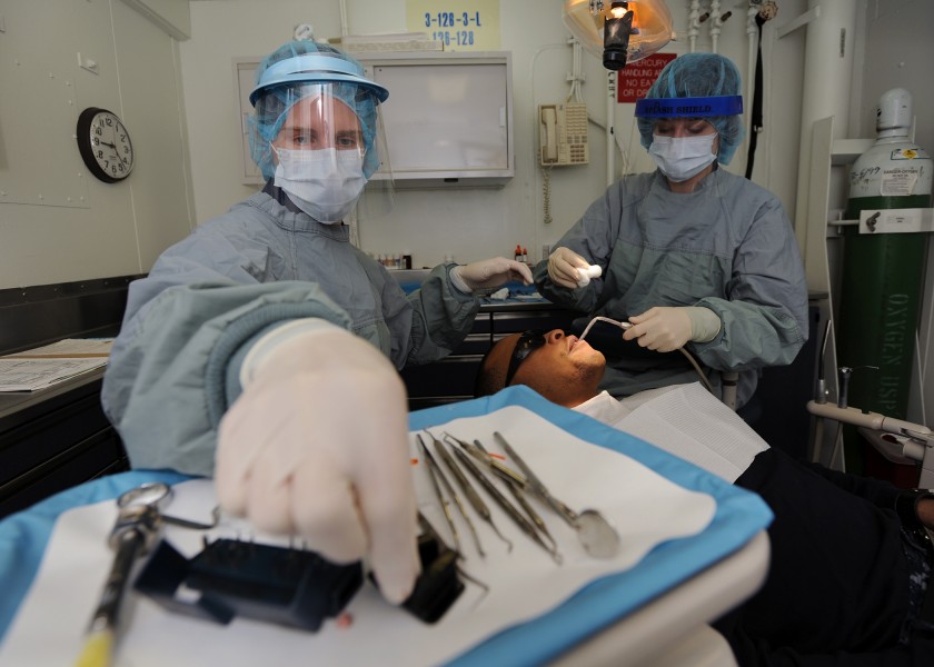 US Navy 110128-N-7095C-043 Lt. Andrea B. Sarge, left, a dentist aboard the aircraft carrier USS Abraham Lincoln (CVN 72), performs a dental procedu