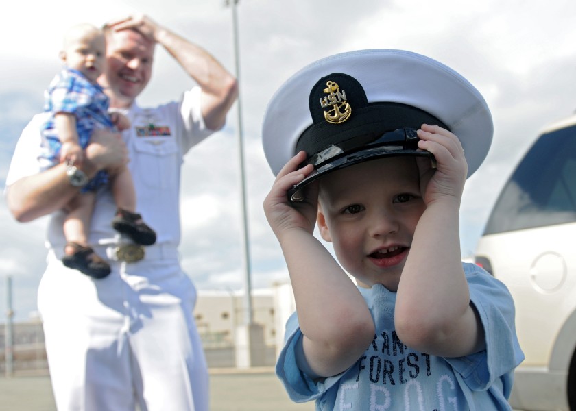US Navy 110310-N-DX615-069 The son of Chief Information Systems Technician Jess Eisele wears his father's cover during a celebration for the arriva