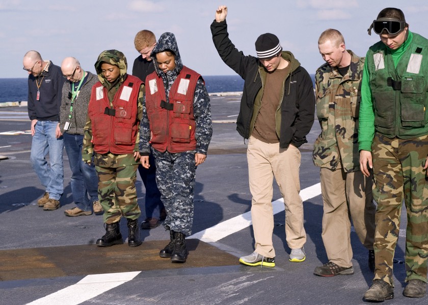 US Navy 110326-N-9626Y-015 Sailors and civilian shipyard workers conduct a foreign object debris walk down after a vertical replenishment at sea ab