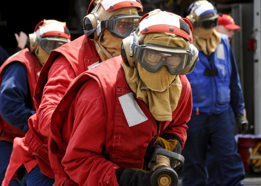 US Navy 110711-N-YM590-008 Sailors approach a simulated fire on the flight deck of the guided-missile cruiser USS Anzio (CG 68) during a flight dec