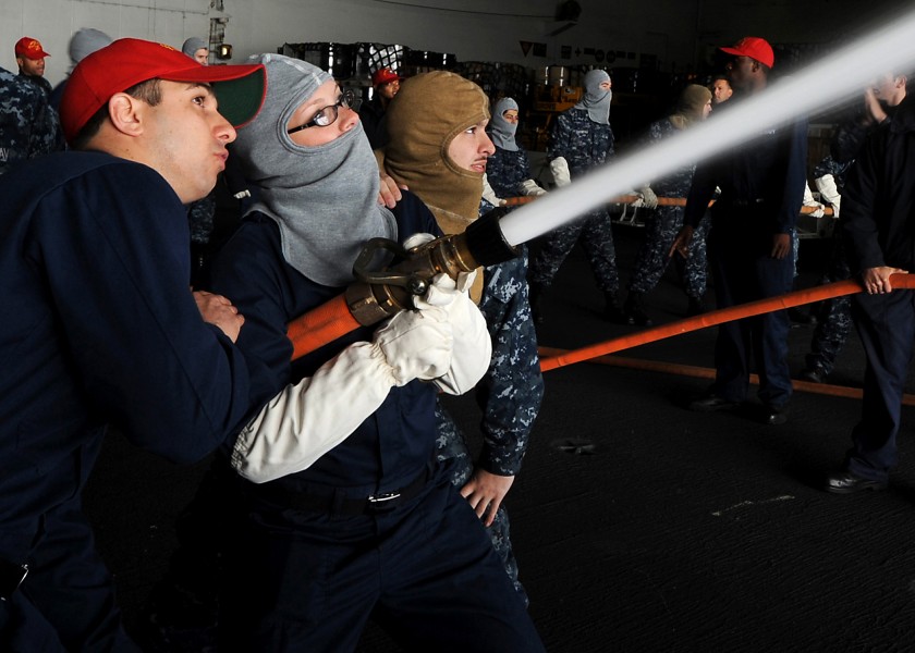 US Navy 110714-N-QN972-005 Aviation Electrician's Mate 1st Class Ken Gaal, right, from Nashville, Tenn., instructs Logistics Specialist Seaman Recr